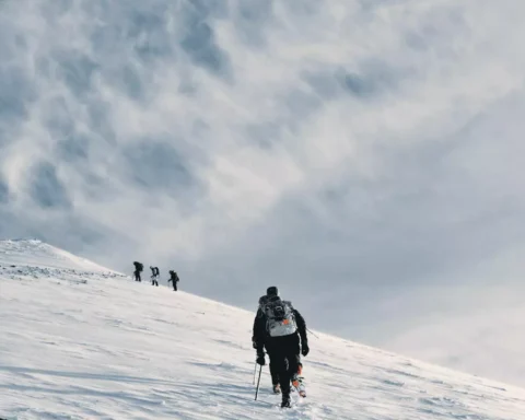 People are climbing the hill covered by snow