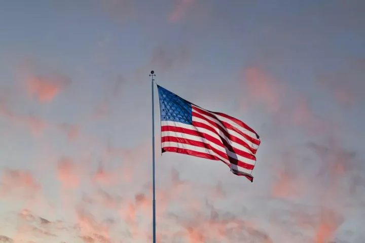 American flag and a sunset sky on the background