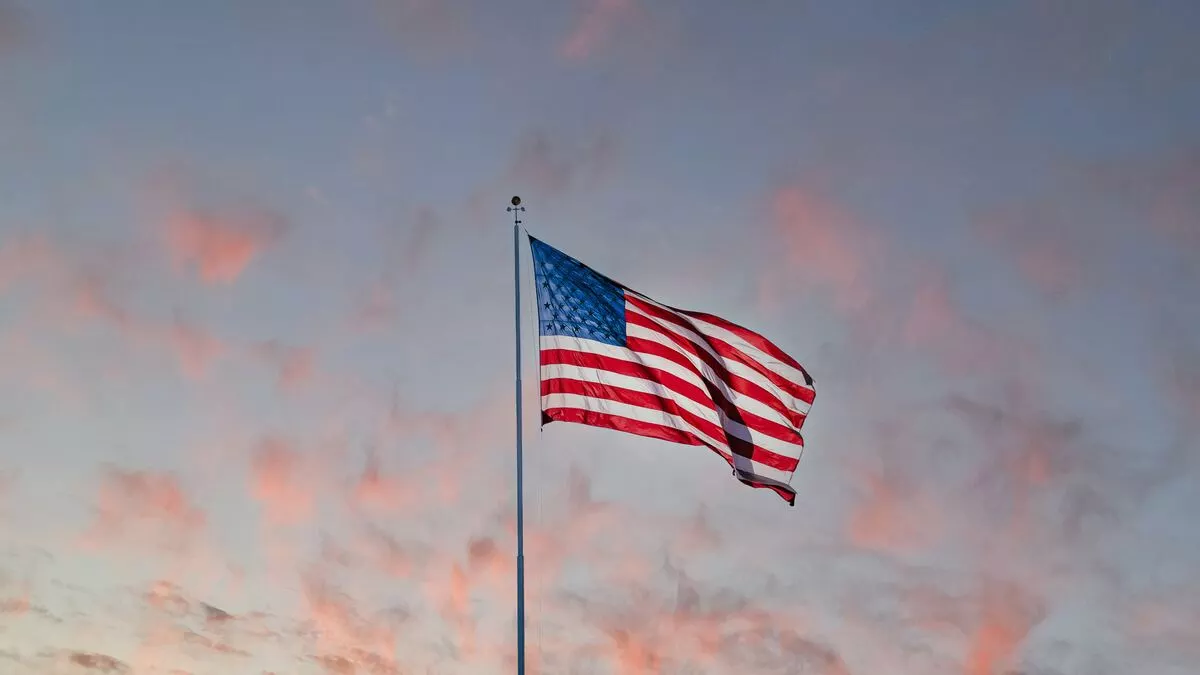 American flag and a sunset sky on the background