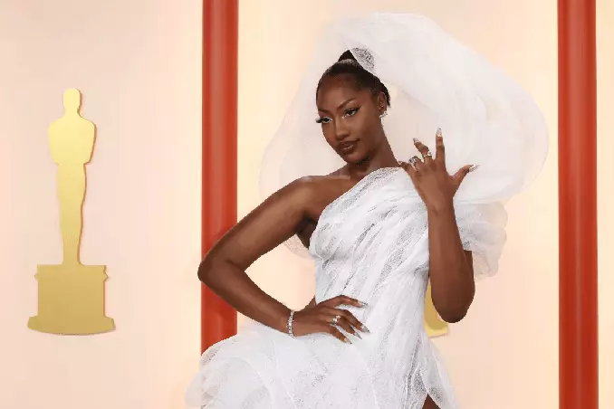 Tems is posing in white dress at 95th Academy Awards