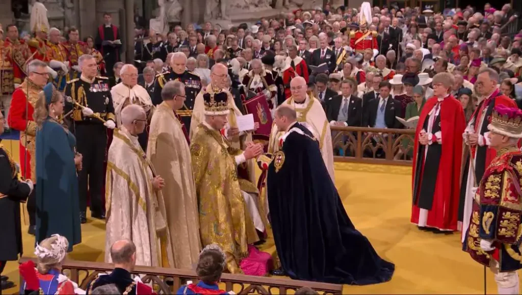 Prince William kisses the new King of England, his father